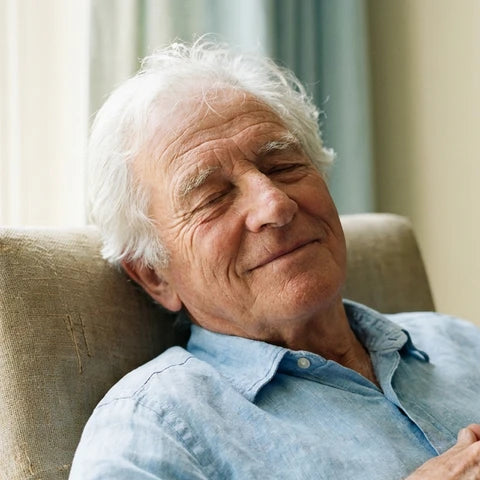 Illustrative image: a relaxed older man resting in an armchair