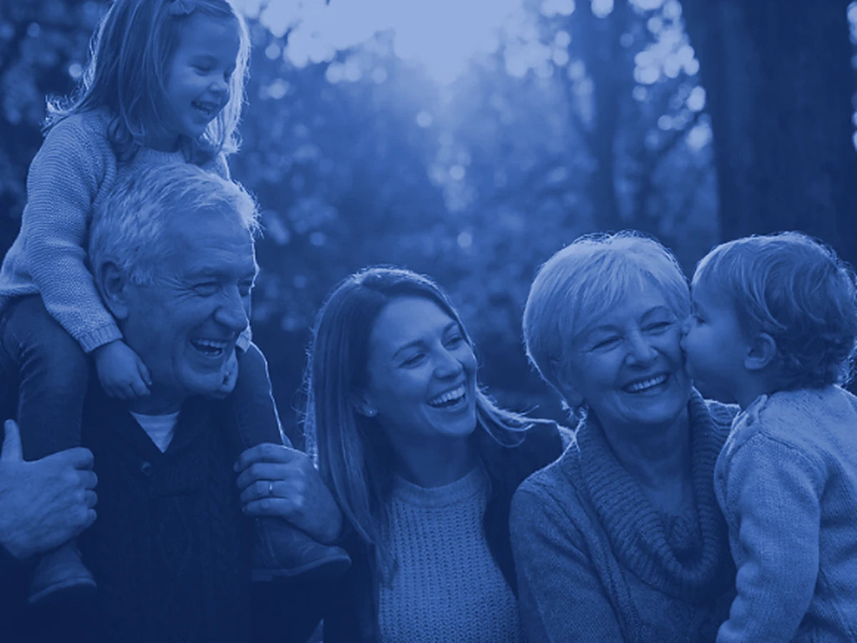 Illustrative image: three generations of a family laughing together outdoors